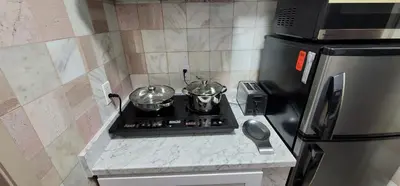 a kitchen with a stove with two pots on it at The Cozy Corner in Canoga in Canoga Park