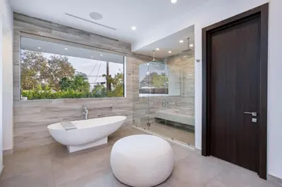 a bathroom with a tub and a toilet and a sink at Ultra Luxe Estate With Pool and Stunning 360 LA Views in Los Angeles