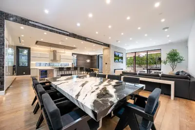 a large marble table in a living room with chairs at Ultra Luxe Estate With Pool and Stunning 360 LA Views in Los Angeles