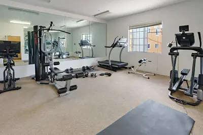 a gym with several treadmills and exercise bikes at Urban retreat- Quiet comfy 1 bedroom condo near LAX in Los Angeles
