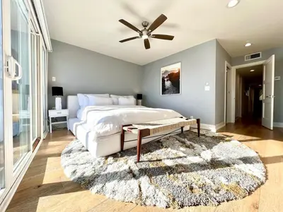 a bedroom with a bed and a ceiling fan at Malibu Waterfront Gallery with Private Beach Access in Malibu Beach