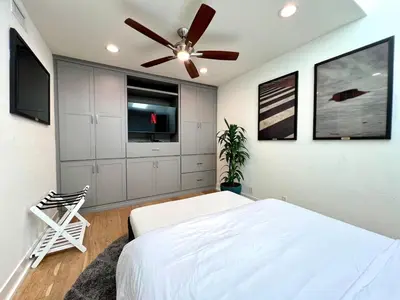 a bedroom with a bed and a ceiling fan at Malibu Waterfront Gallery with Private Beach Access in Malibu Beach