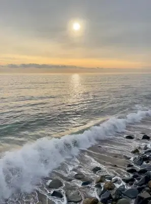 a beach with the sun rising over the water at Malibu Waterfront Gallery with Private Beach Access in Malibu Beach