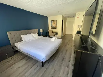 a bedroom with a large white bed and blue walls at Modern Apart in Beverly Hills in Los Angeles
