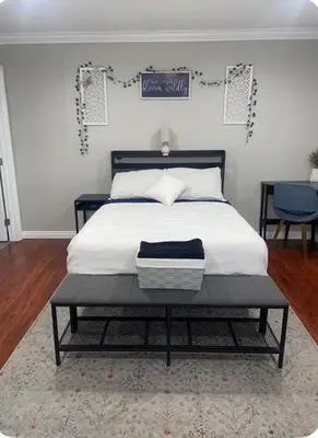 a bedroom with a bed with a black and white bed frame at The stay go in Gardena