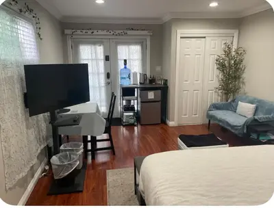a living room with a bed and a television at The stay go in Gardena