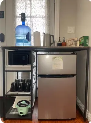 a kitchen with a table and a small refrigerator at The stay go in Gardena