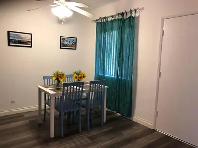 a dining room table with chairs and a ceiling fan at Modern 1 Bedroom Hollywood Apartment Near Larchmont Village Walk of Fame and Studios in Los Angeles