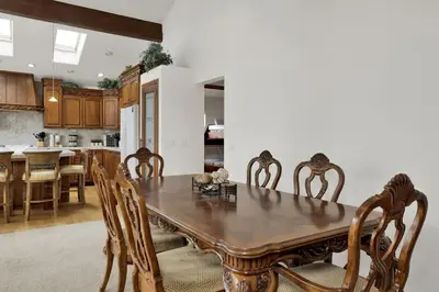 a kitchen and dining room with a wooden table and chairs at Vivienda De Osos Walk to the Lake Spacious Fawnskin Retreat Chalet in Fawnskin