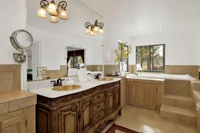 a bathroom with two sinks and a large mirror at Vivienda De Osos Walk to the Lake Spacious Fawnskin Retreat Chalet in Fawnskin