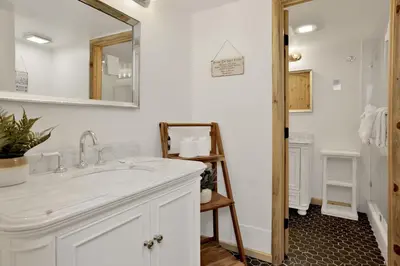 a bathroom with a sink and a mirror at Ours De Ski Chateau at Snow Summit - Big Bear Basecamp Resort Condo w/ Hot Tub in Big Bear Lake