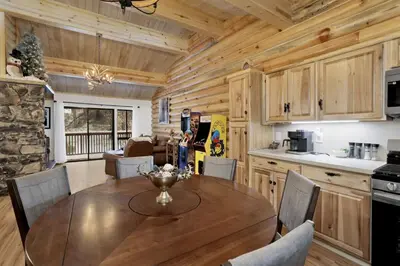 a kitchen and dining room with a table and chairs at Ours De Ski Chateau at Snow Summit - Big Bear Basecamp Resort Condo w/ Hot Tub in Big Bear Lake