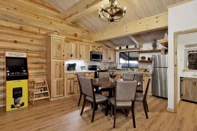 a kitchen with a table and chairs in a cabin at Ours De Ski Chateau at Snow Summit - Big Bear Basecamp Resort Condo w/ Hot Tub in Big Bear Lake
