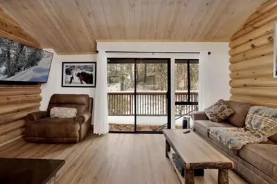 a living room with a couch and a table at Ours De Ski Chateau at Snow Summit - Big Bear Basecamp Resort Condo w/ Hot Tub in Big Bear Lake