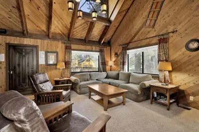a living room with a couch and a table at Crystal Pines at Big Bear Lake Walk to Boulder Bay Park Family-Friendly Retreat in Big Bear Lake