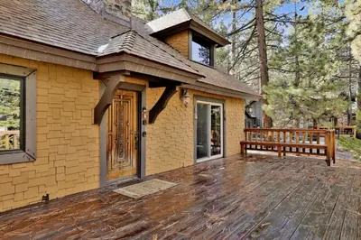 a house with a wooden deck in front of it at Crystal Pines at Big Bear Lake Walk to Boulder Bay Park Family-Friendly Retreat in Big Bear Lake