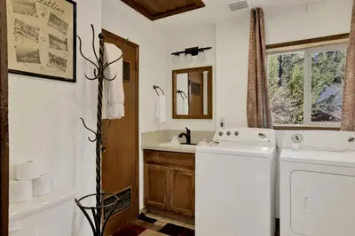 a bathroom with a washer and dryer in it at Crystal Pines at Big Bear Lake Walk to Boulder Bay Park Family-Friendly Retreat in Big Bear Lake