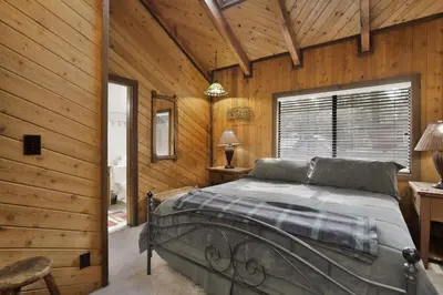 a bedroom with a bed in a wooden cabin at Crystal Pines at Big Bear Lake Walk to Boulder Bay Park Family-Friendly Retreat in Big Bear Lake