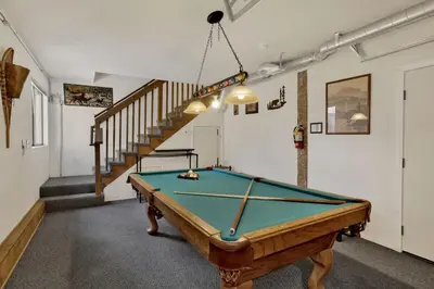 a pool table in a room with a staircase at Crystal Pines at Big Bear Lake Walk to Boulder Bay Park Family-Friendly Retreat in Big Bear Lake