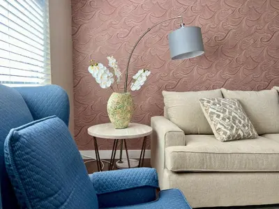 a living room with a couch and a chair and a table at Golden Downey Designer Abode - Poolside Suite in Downey