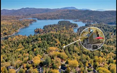 an aerial view of a house on a hill next to a lake at Relaxing 4 bedroom Mountain Stay in Lake Arrowhead