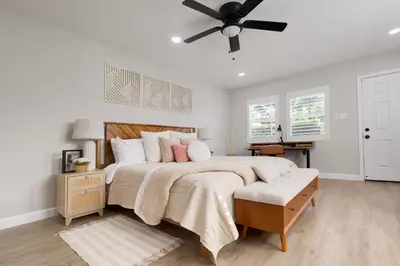 a bedroom with a large bed with a ceiling fan at Elegant 3 Bedroom 2 Bathroom With EV Charging Near Santa Anita in Duarte