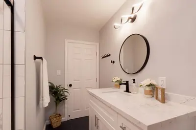 a white bathroom with a sink and a mirror at Elegant 3 Bedroom 2 Bathroom With EV Charging Near Santa Anita in Duarte