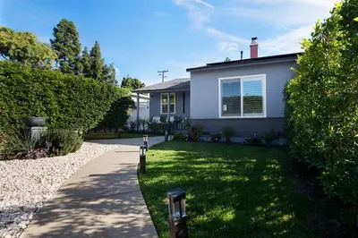 a house with a grass yard and a driveway at Elegant 3 Bedroom 2 Bathroom With EV Charging Near Santa Anita in Duarte