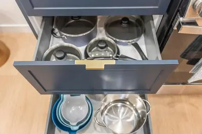 a stove top with pots and pans in a drawer at New 1 BR, King Bed, Laundry In-Unit, Parking in Los Angeles