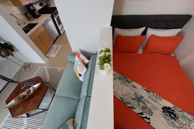 a small bedroom with a bed and a couch at Coastal Luxe | Walk to Pier + Free Parking in Los Angeles