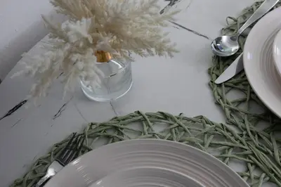 a table with a plate and a vase with a plant at Stylish Santa Monica Apt Free Parking & Wi-Fi in Los Angeles
