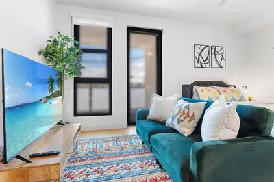 a living room with a blue couch and a tv at Laugh in the Lap of Luxury In SM * FREE Parking * in Los Angeles