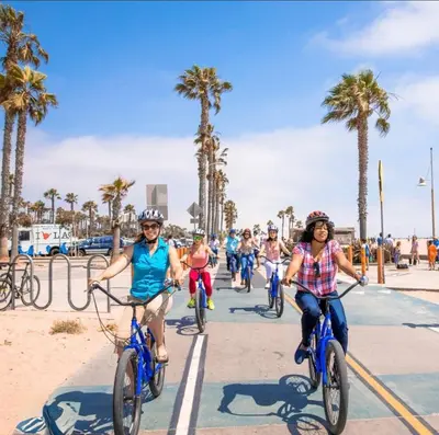 a group of people riding bikes on the beach at Laugh in the Lap of Luxury In SM * FREE Parking * in Los Angeles