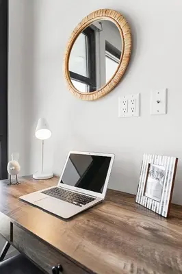 a laptop computer sitting on a wooden desk with a mirror at * Breathtaking Place In Santa Monica's Heart * in Los Angeles