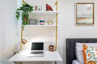 a white desk with a laptop on it next to a couch at Santa Monica's Prestige Place *Steps To The Beach* in Los Angeles