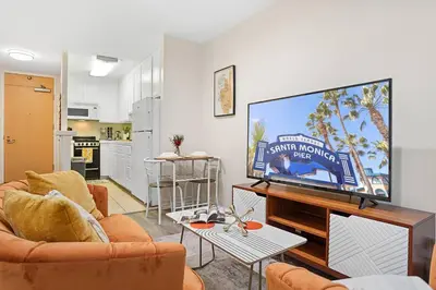 a living room with a large flat screen tv at Santa Monica's Prestige Place *Steps To The Beach* in Los Angeles