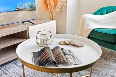 a white coffee table with books and sandals on it at * Sand & Surf In The Heart Of Santa Monica * in Los Angeles