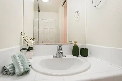a white bathroom with a sink and a mirror at * Sand & Surf In The Heart Of Santa Monica * in Los Angeles