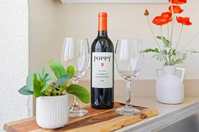 a bottle of wine and two wine glasses on a counter at * Sand & Surf In The Heart Of Santa Monica * in Los Angeles