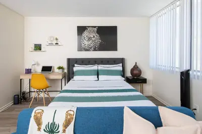 a bedroom with a bed and a desk with a laptop at Wake Up to Waves – Beachside Bliss In Santa Monica in Los Angeles