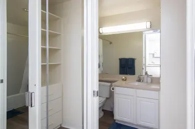 a bathroom with a sink and a toilet and a mirror at Wake Up to Waves – Beachside Bliss In Santa Monica in Los Angeles