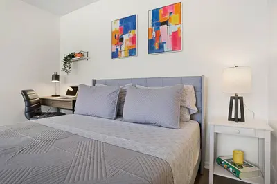 a bedroom with a bed and a desk at SoCal Luxurious Apt Steps To The Beach & Pier in Los Angeles