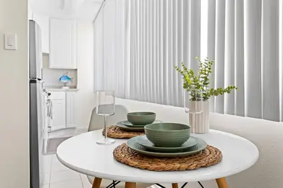 a white table with two green dishes on it at Beachside Beauty Steps To The Beach & Restaurants in Los Angeles