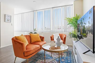 a living room with a couch and a table at Beachside Beauty Steps To The Beach & Restaurants in Los Angeles
