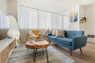 a living room with a blue couch and a table at Ocean Lover's Dream Studio In Santa Monica in Los Angeles