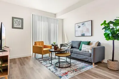 a living room with a couch and a table at 5 Star 1BR Apartment w/ Free Parking & Fast WiFi in Los Angeles