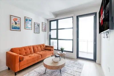 a living room with an orange couch and a table at Santa Monica 1BR apt with Parking in Los Angeles