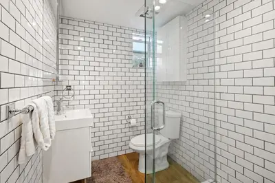 a bathroom with a toilet and a glass shower at Modern 1BR • Steps to Venice Beach in Los Angeles