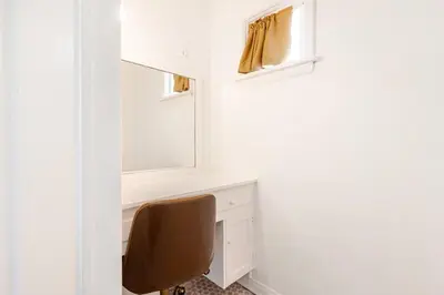 a desk with a mirror and a chair in a room at Cozy 3-Bedroom Home in K-town Los Angeles in Los Angeles