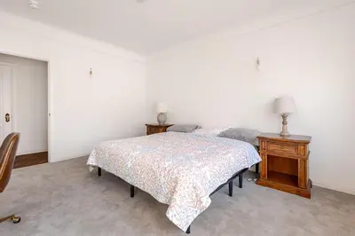 a bedroom with two beds and a nightstand with two lamps at Cozy 3-Bedroom Home in K-town Los Angeles in Los Angeles